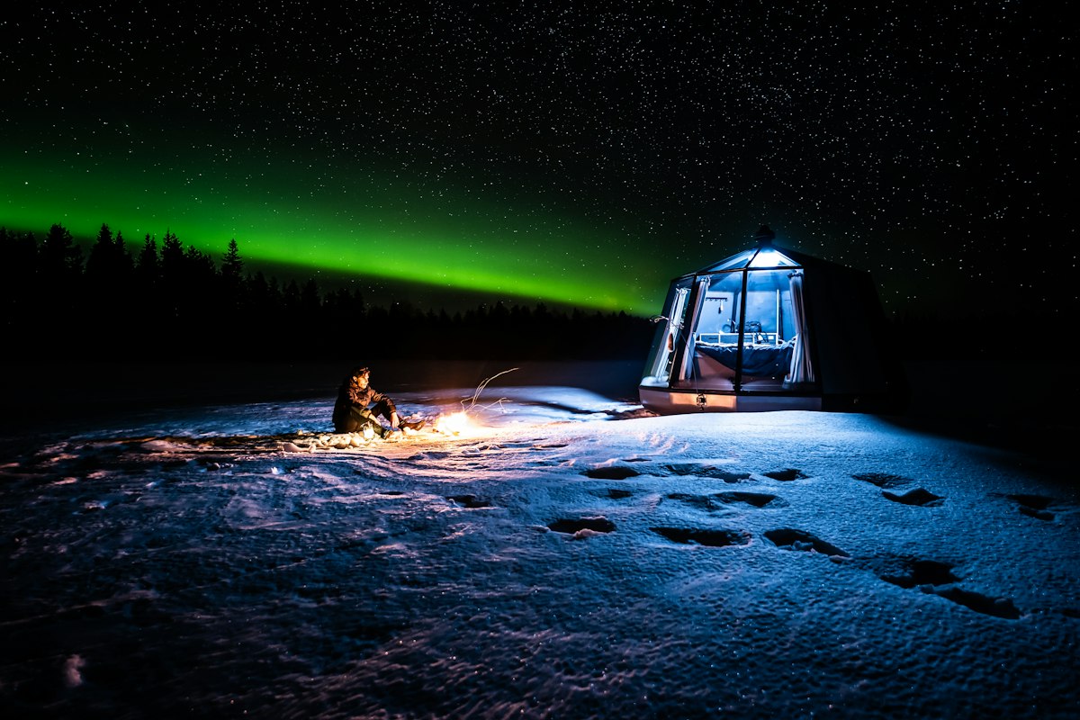 A glass igloo under the northern lights, Finnish Lapland