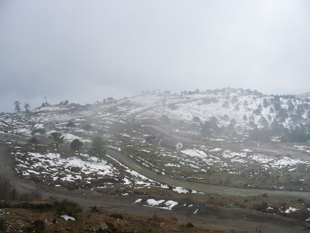 Snow and mist on the hills near Tawang